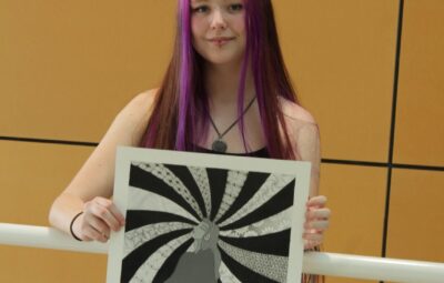 Cadence Pitts Holding Her Artwork