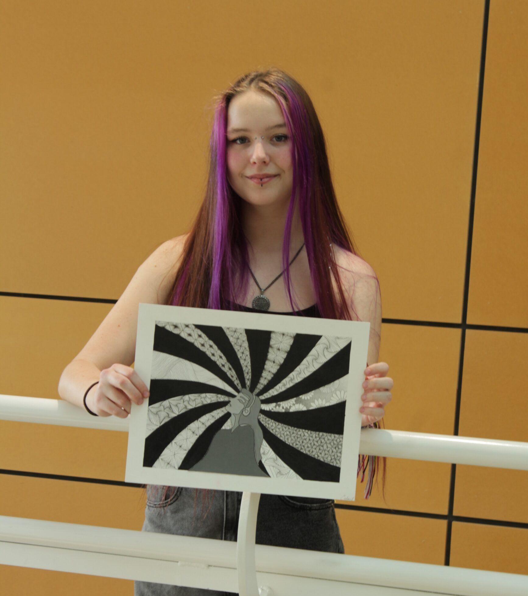 Cadence Pitts Holding Her Artwork