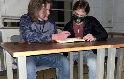 One Student With a Mask and Another Without