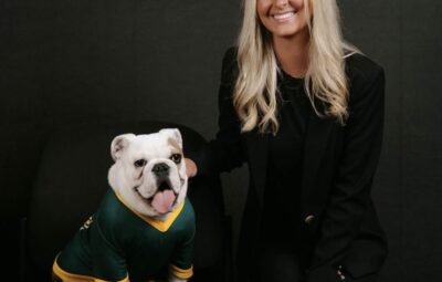 New Faculty member Hunter Rainey poses with Jerry the Bulldog