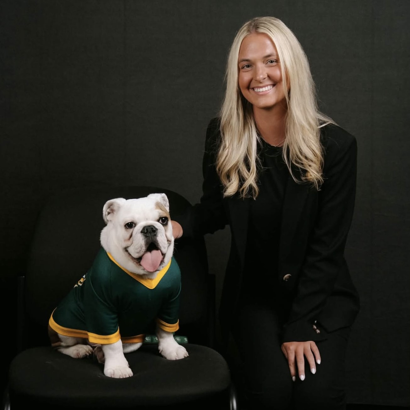 New Faculty member Hunter Rainey poses with Jerry the Bulldog
