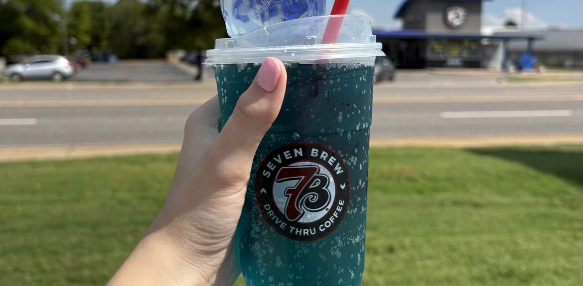 Blue 7 Brew Doh squishy and 7 Energy drink in front of 7 Brew building